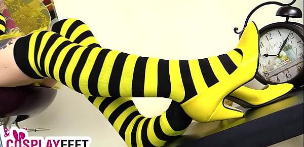  Cosplayer in bee costume shows feet in striped stockings
